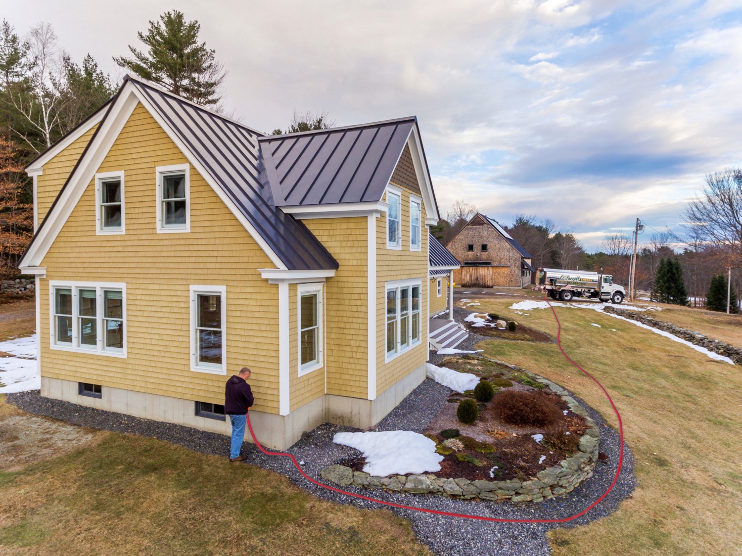 O'Farrell Energy truck delivering heating oil to a home in Midcoast Maine